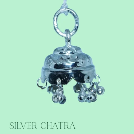 Pure silver Chattra placed above deity idol in home temple